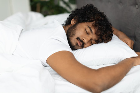 Closeup shot of young indian man sleeping in bed