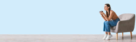 Dreamy young caucasian woman drinking coffee, banner with copy spaceの写真素材