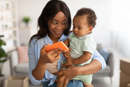 Portrait of African American family using cellphone at homeの写真素材