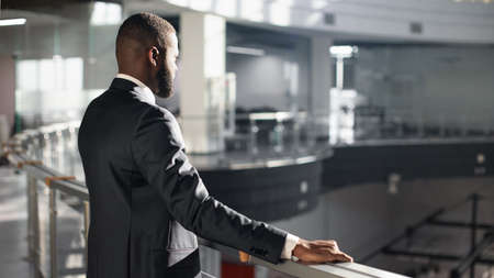 Pensive african american entrepreneur standing by railing