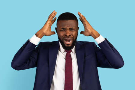 Portrait Of Desperate Black Businessman Emotionally Reacting To Failureの写真素材