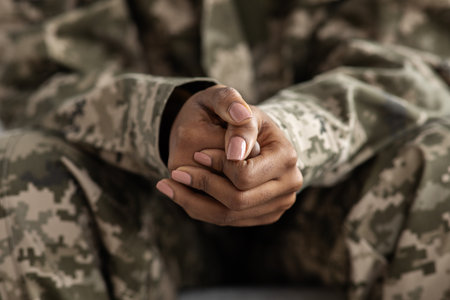 Clasped Hands Of Black Soldier Woman In Camouflage Uniform, Closeup Shotの写真素材