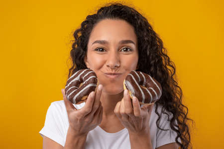 Funny Latin Lady Holding Chewing Doughnut Cake At Studio