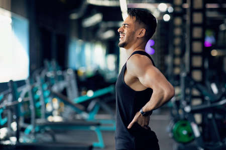 Sport Trauma. Young Arab Male Athlete Suffering Lower Back Pain During Trainingの写真素材