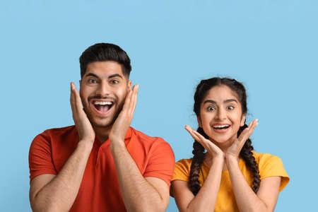 Great Deal. Amazed Arab Spouses Looking At Camera And Touching Face