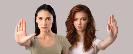 No Abuse. Two Upset Young Women Gesturing STOP At Cameraの写真素材