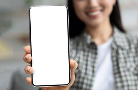 Big Blank Smartphone With White Screen In Young Asian Female Hand