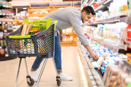 Middle Eastern Male Taking Product Shopping Groceries In Supermarketの写真素材