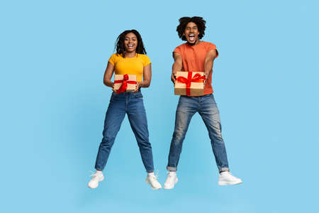 Cheerful african american couple showing their gifts