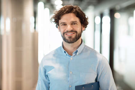 Portrait of smiling business man posing looking at camera