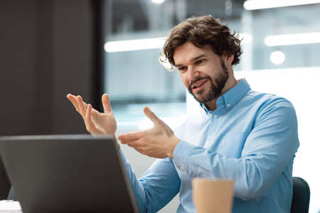 Business man having video call using laptop and talking