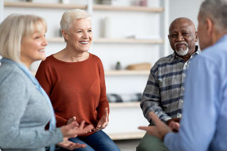 Excited multiethnic elderly people attending group therapy sessionの写真素材