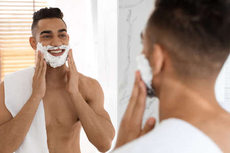 Morning Shaving. Handsome Shirtless Arab Guy Applying Shave Foam On Faceの写真素材