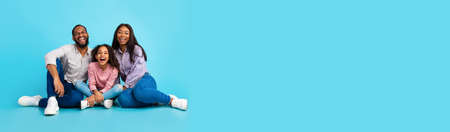 Portrait Of Happy African American Family With Teen Daughter Over Blue Background