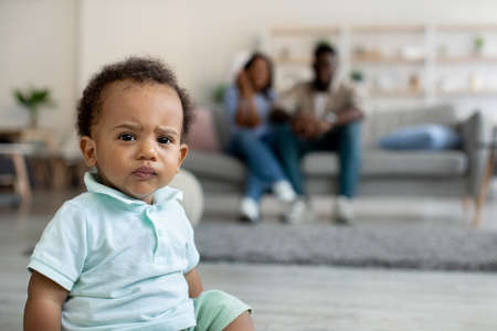 Serious angry African American baby boy looking at camera