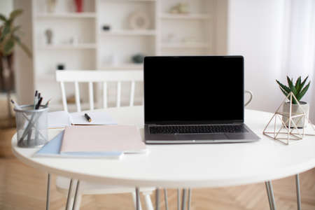 Laptop Computer With Empty Screen Standing On Table At Homeの写真素材