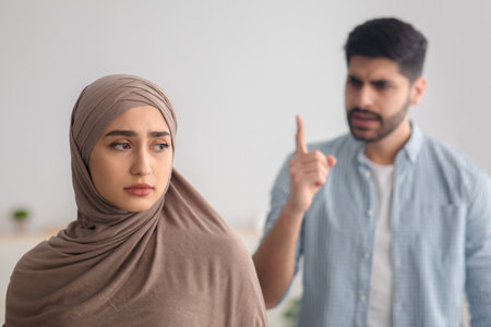 Angry Muslim Man Yelling At Depressed Wife Having Conflict Indoorの写真素材
