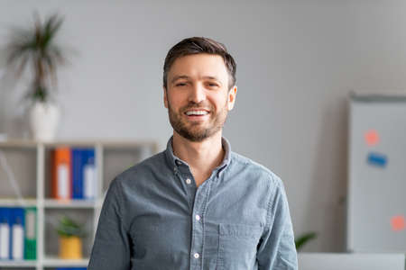 Closeup portrait of mature businessman posing at office, handsome middle aged manager in formal wear