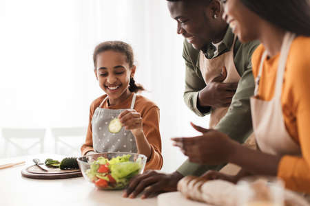 Joyful Black Family Making Salad Cooking In Kitchen, Selective Focusの写真素材