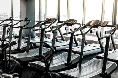Closeup Shot Of Modern Treadmills Standing In Row At Empty Gymの写真素材