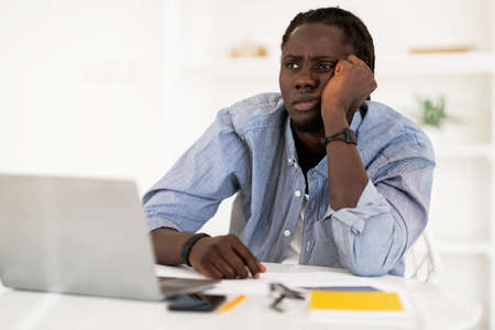 Freelance Burnout. Portrait Of Bored Black Man Sitting At Desk With Laptop