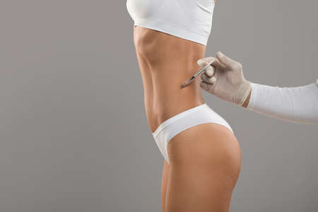 Beauty Treatments. Slim Female In Underwear Getting Lipolysis Injection At Aesthetic Clinic