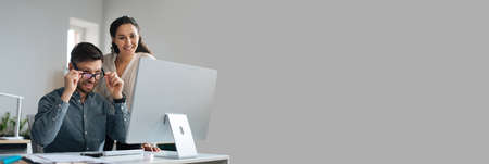 Two happy colleagues working on startup project together, copy space