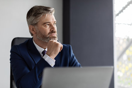 Business Planning. Portrait Of Thoughtful Mature Businessman At Workplace In Officeの写真素材
