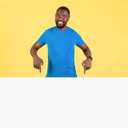 Black Guy Pointing Fingers At White Board Over Yellow Backgroundの写真素材