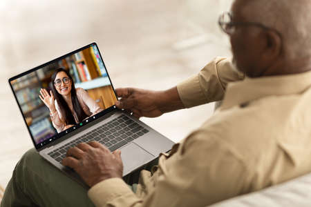 Remote Meeting. Senior Black Man Having Video Call With Young Female On Laptop