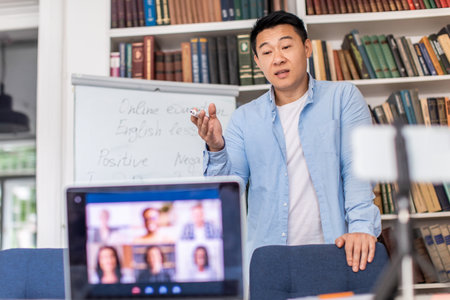 Chinese Teacher Having Distance Class Making Group Video Call Indoorsの写真素材