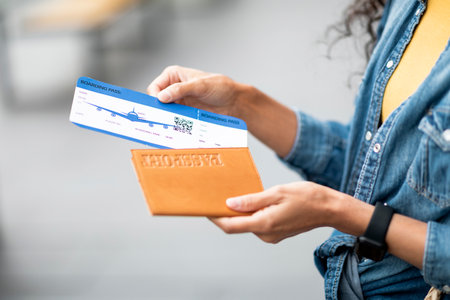 Cropped of female hands holding flight tickets and passportの写真素材