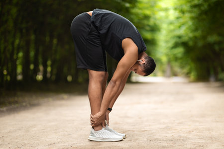 Athletic middle eastern young man exercising at public parkの写真素材