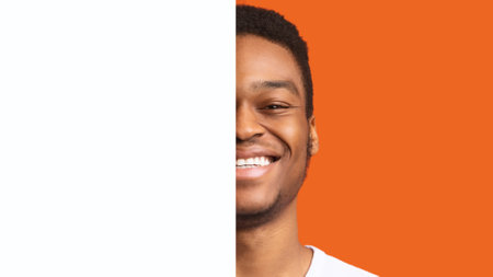 Half Portrait Of Black Male Posing With Board, Orange Backgroundの写真素材