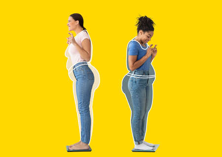 Inspired black and european young women, fat ladies drawn around, with crossed fingers checking weight on scalesの写真素材