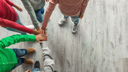 Unrecognizable Kids Putting Hands Together Standing Indoors, Top View