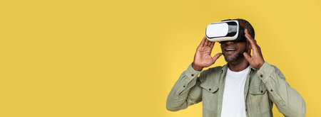 Glad adult african american male in casual and VR glasses enjoy online game, have fun