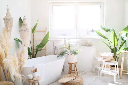 Cozy Stylish Light Bathroom Interior In Boho Style With White Bath Tubeの写真素材