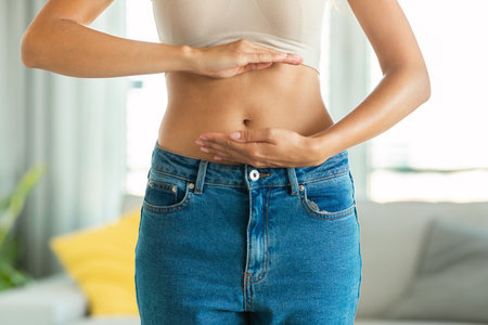 Unrecognizable Slim Woman Framing Flat Stomach And Belly Button Indoor
