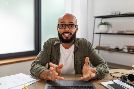 Head shot portrait of mature male employee talking on video call with colleague or business partner,...