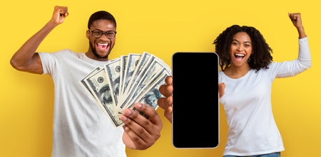 Overjoyed black couple holding a lot of cash and smartphone