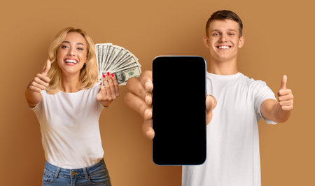 Cool youngsters showing smartphone and cash, gesturing thumb ups, mockup