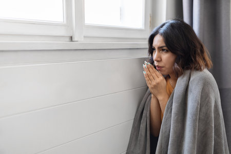 Energy Crisis. Freezing Arab Woman Sitting Near Cold Radiator At Homeの写真素材