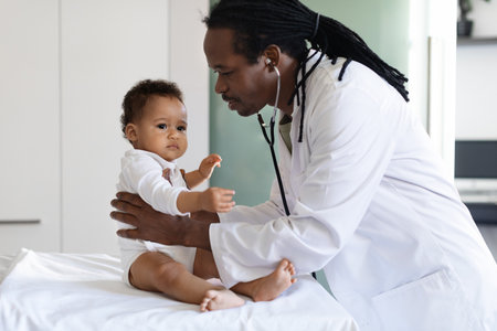 Baby Check Up. Black Pediatrician Doctor Examining Little Infant Boy In Clinicの写真素材