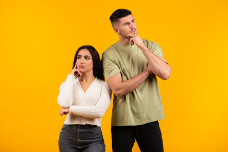 Pensive millennial middle eastern husband and wife thinking, look in different directions