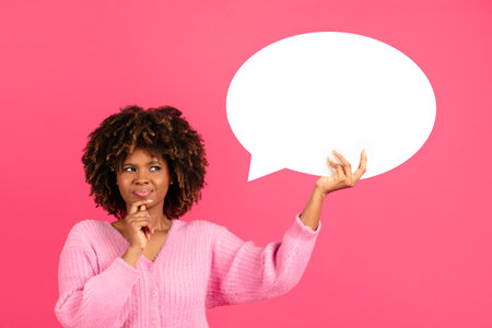 Pensive millennial african american curly woman in casual hold abstract cloud, bubble for thoughts and wordsの写真素材