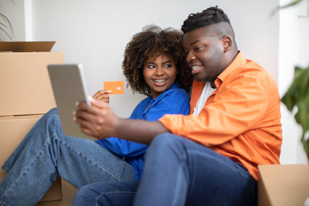 Online Shopping. Black Smiling Couple Using Digital Tablet And Credit Cardの写真素材