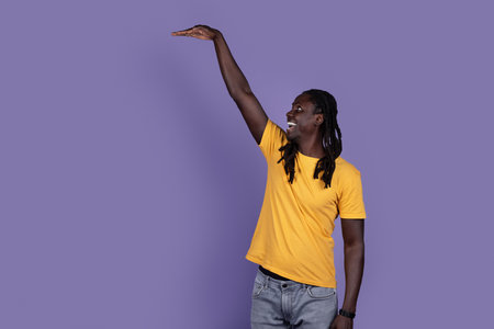 Excited african american guy showing height of something invisible