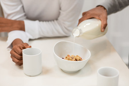Cropped of black couple have breakfast together at home