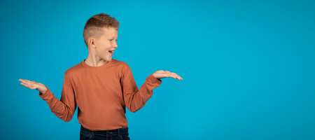 Make Choice. Cheerful preteen boy making scales with his empty palms,